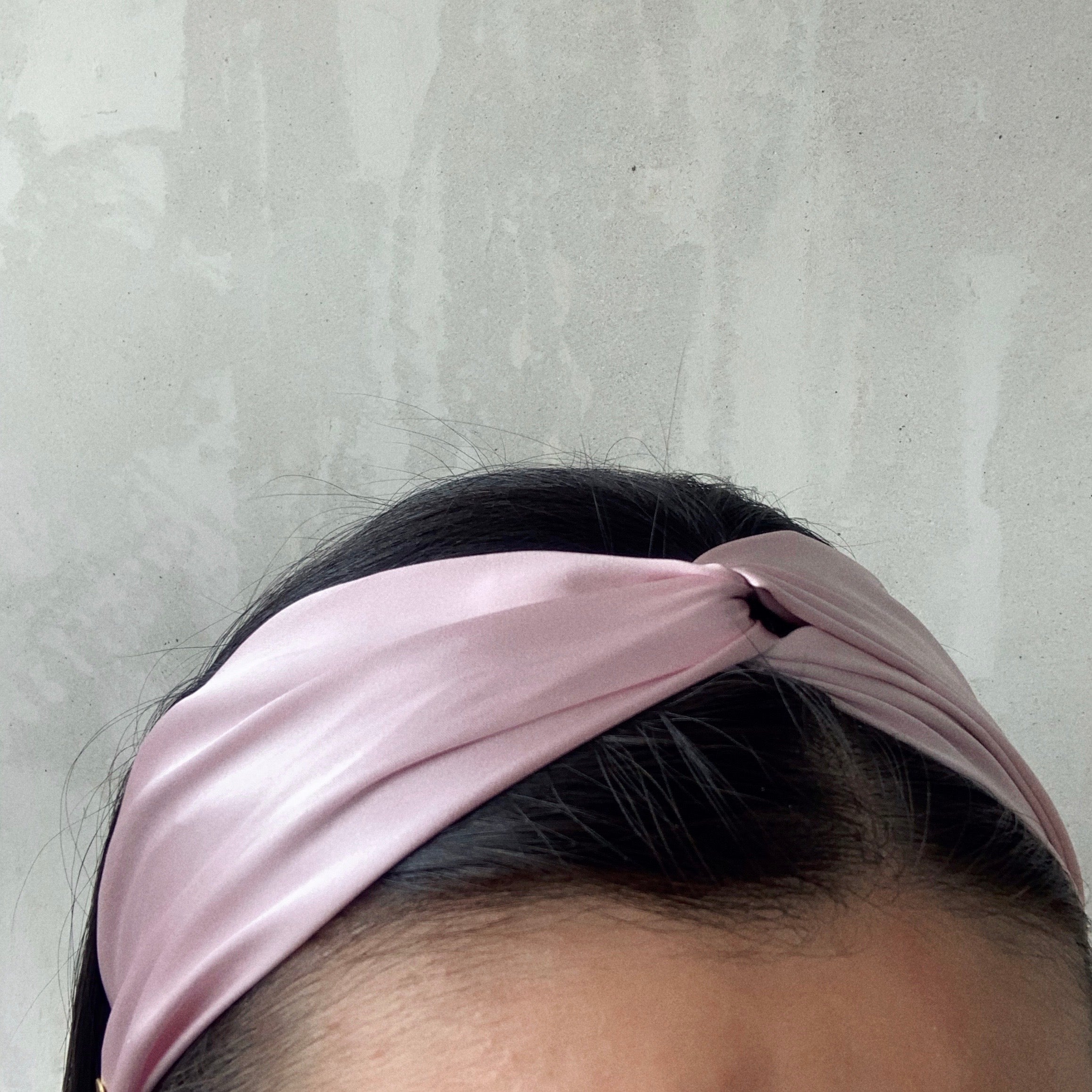 Dusty Rose - model wearing light pink satin twisted headband.