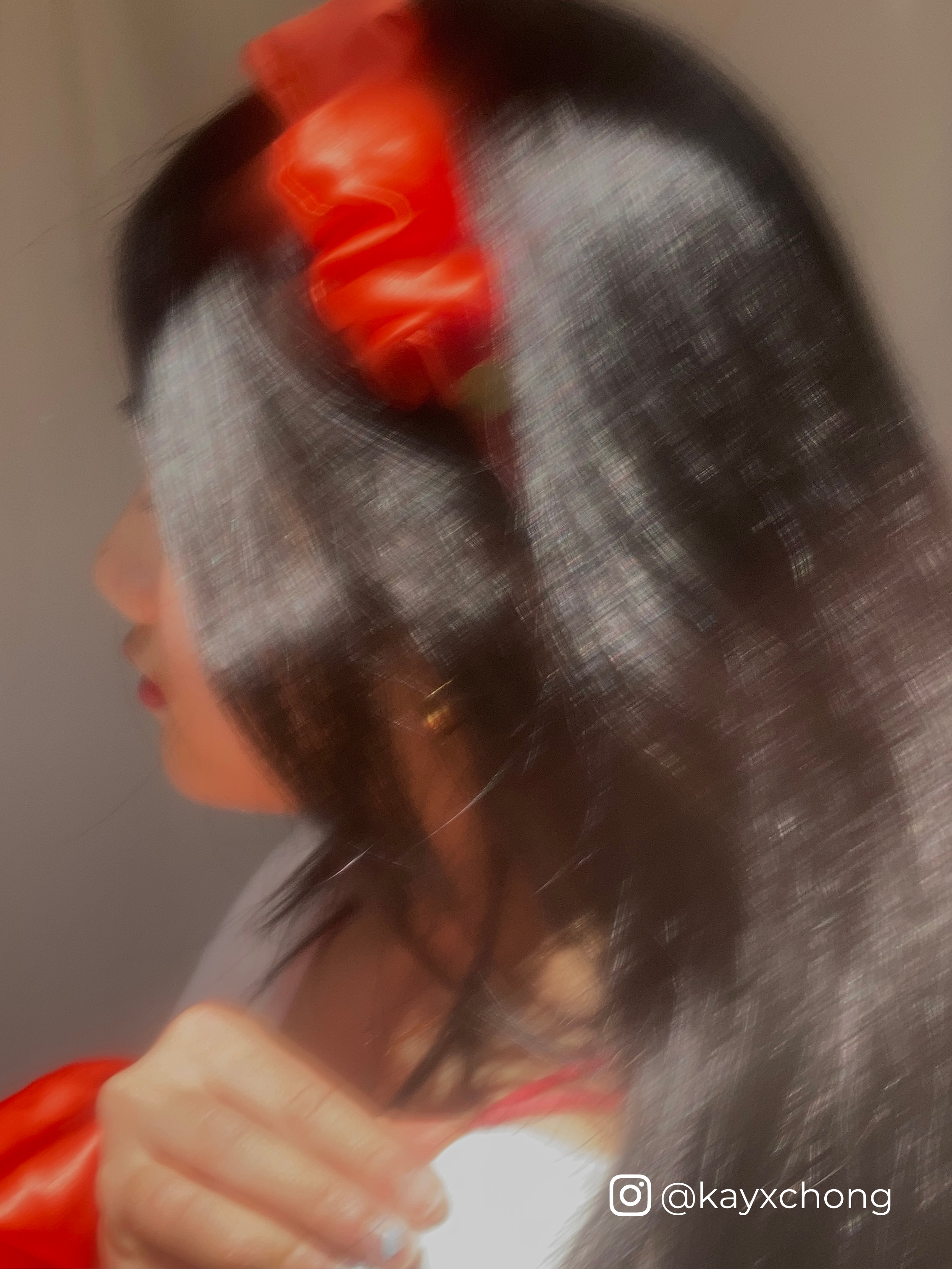 Influencer Kay Chong wearing our tangerine silk scrunchie headband and standard size scrunchie.